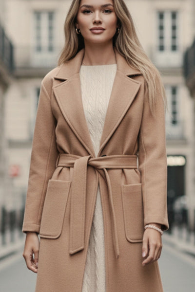 Abrigo largo de manga larga, con solapa, bolsillos delanteros de parche, trabillas y cinturón amarrable del mismo tejido.