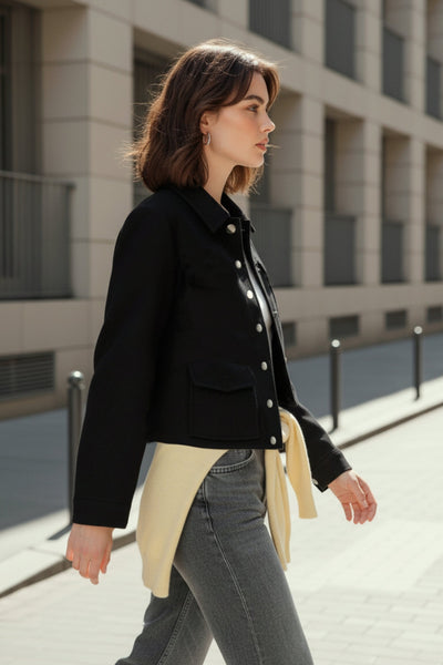 Abrigo corto de fit recto, manga larga, cuello solapa, bolsillos delanteros de parche con cartera y cierre frontal con hilera de botones en contraste.