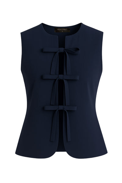 Blusa de fit ajustado, cuello redondo, sin mangas y cierre frontal con lazos amarrables. Detalle de bajo curveado frontal.