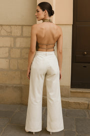 Blusa corta satinada de cuello halter con escote fluido, sin mangas y escote en espalda con tirantes delgados ajustables.