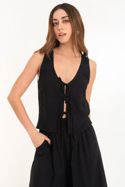 Blusa de fit recto, sin mangas, escote v redondeado y cierre frontal con lazos amarrables.