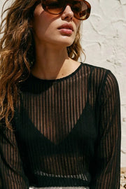 Blusa túnica de cuello redondo, manga larga con puño amplio, bajo frontal asimétrico, corte en a, cierre posterior con botón y ojal. Detalle de rayas contraste en tejido.