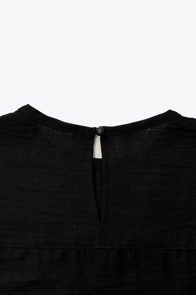 Camisa de fit amplio, costuras decorativa frontales con plisados, manga larga abullonada con rib elástico en puños, cuello redondo, olanes decorativos en sisa, cierre posterior con botón y ojal.