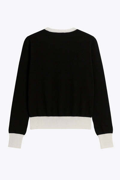 Cardigan de punto, fit recto, manga larga con rib de contraste en puños, bajo y cuello redondo. Cierre frontal con hilera de botones en contraste.