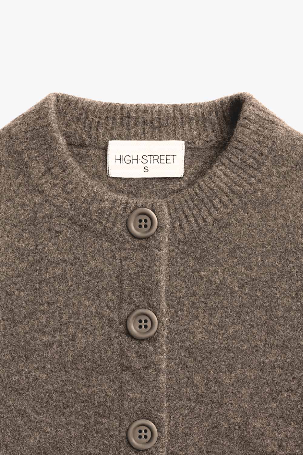 Cardigan de punto, fit recto, manga larga con rib de contraste en puños y cuello redondo. Cierre frontal con hilera de botones.