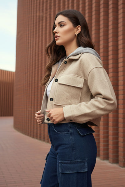 Chamarra corta de fit recto, manga larga con puño abotonado, cuello camisero, capucha en contraste, bolsillos delanteros de parche con cartera y cierre frontal con hilera de botones en contraste.