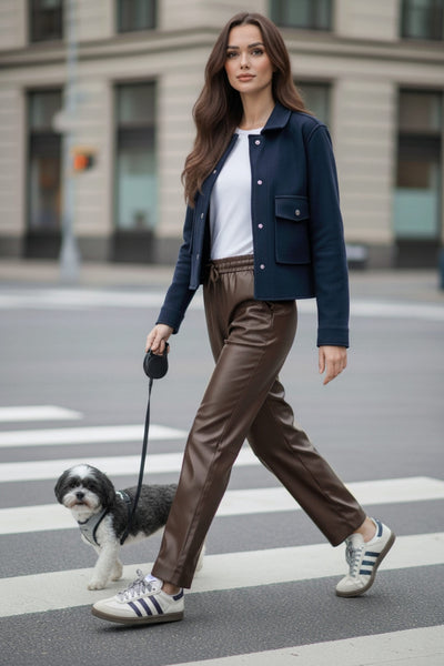 Chamarra corta de fit recto, cuello camisero, manga larga con puño abotonado, bolsillos delanteros con cartera y botón. Cierre frontal con hilera de botones en contraste.