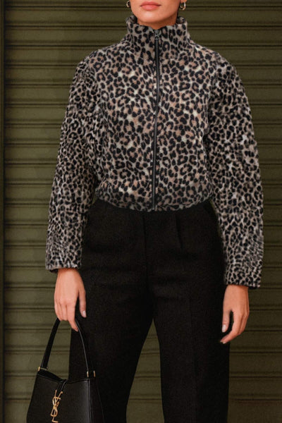 Chamarra de efecto borreguillo, estampado leopardo, manga larga, cuello alto y cierre frontal con cremallera visible en contraste.