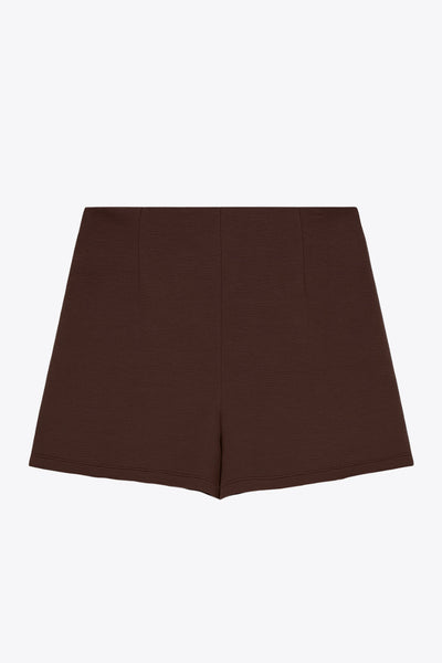 Falda short corto de cintura alta, corte en a, cruce frontal con plisados frontales y cierre lateral con cremallera oculta.