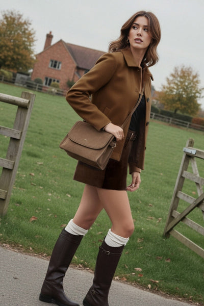 Falda short corto de gamuza, fit ajustado, cintura alta con pretina y trabillas, bolsillos delanteros, cierre frontal con botón y cremallera oculta.