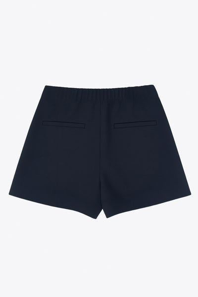 Falda short corto de cintura alta con pinzas y tableado frontal, corte en a, vivos decorativos posteriores y cierre lateral con cremallera oculta.