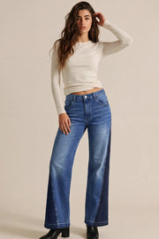 Pantalón de denim, fit wide leg, tiro medio, pretina con trabillas, bolsillos delanteros y traseros de parche. Cierre frontal con botón y cremallera oculta. Detalle decorativo lateral en contraste y rotos en bajo.