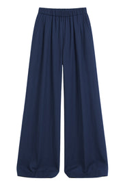 Pantalón de lino, fit palazzo, cintura baja con pretina elástica, bolsillos delanteros y pinzas frontales.