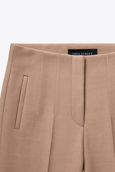 Pantalón de fit recto, cintura alta con pinzas, vivos decorativos frontales, detalle posterior en v, raya frontal y posterior. Cierre frontal con cremallera oculta.