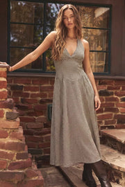 Vestido midi de estampado cuadros, cuello halter con nudo amarrable posterior, escote v con cortes y plisados decorativos, corte en a, plisados en cintura con corte frontal en v y fruncido en espalda.