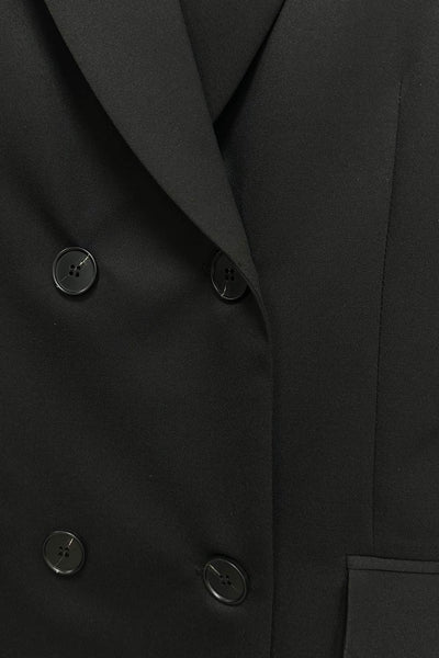 Vestido blazer corto cruzado de corte en a, manga larga, con hombreras y solapa. Cruce frontal con doble botón en contraste, bolsillos delanteros con cartera, trabillas y cinturón amarrable del mismo tejido.